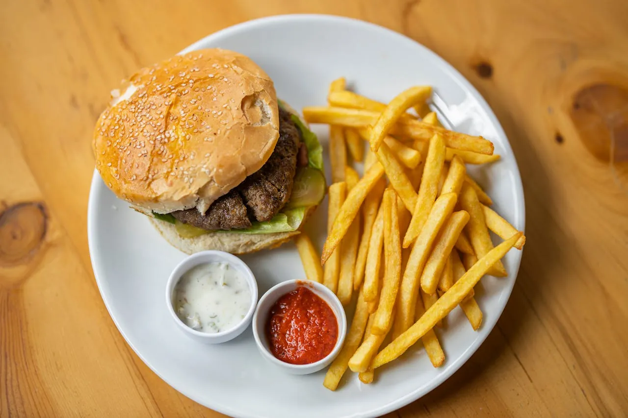 A burger and fries served at a restaurant table